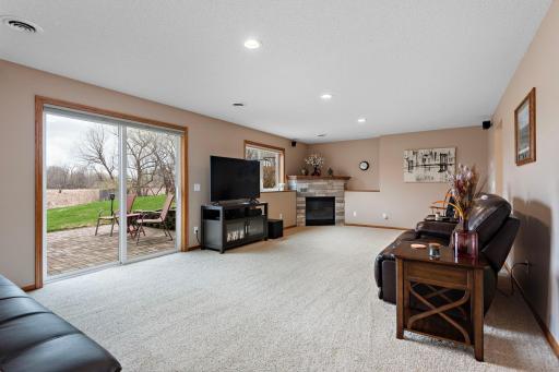 Beautiful lower level Family Room has corner gas fireplace, LED lighting and walks out to patio - outside wiring for your future hot tub!