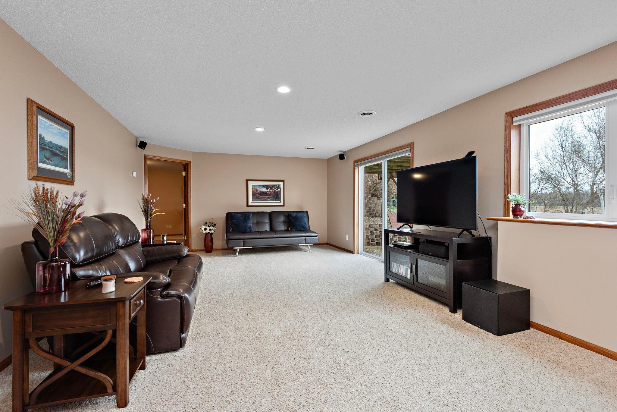 Beautiful lower level Family Room has corner gas fireplace, LED lighting and walks out to patio - outside wiring for your future hot tub!
