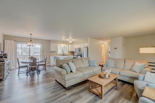 The open-concept layout is flooded with natural light, showcasing large windows that highlight the peaceful surroundings.