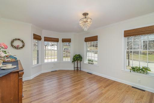 Formal dining room with large windows allowing an abundance of natural light.