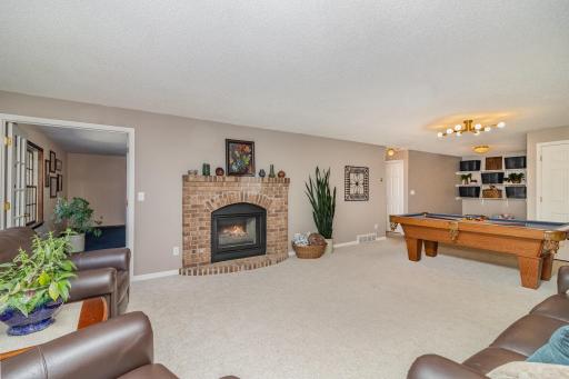 Lower level family room features a 2-sided gas fireplace