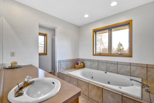 Primary bedroom ensuite bathroom also has separate shower.
