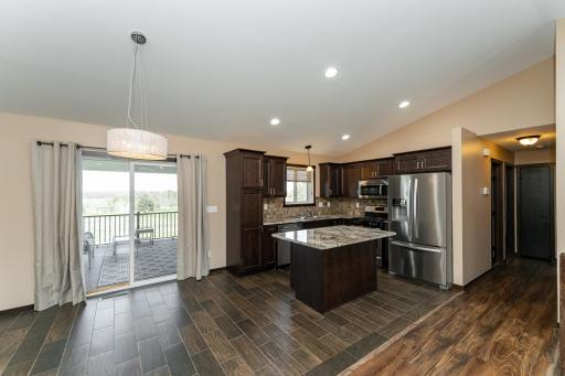 Kitchen with granite tops, tiled backsplash and SS appliances