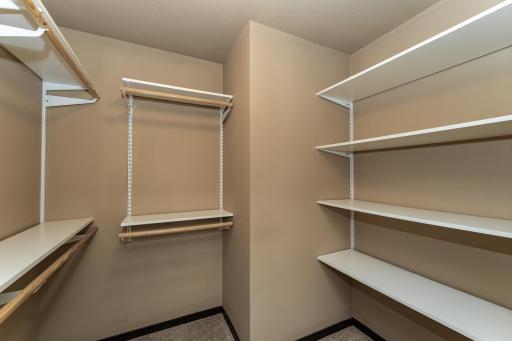 Primary bedroom walk-in closet with shelving