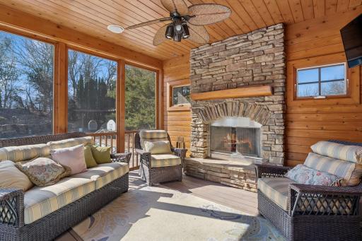 Cozy three season porch with stone fireplace!
