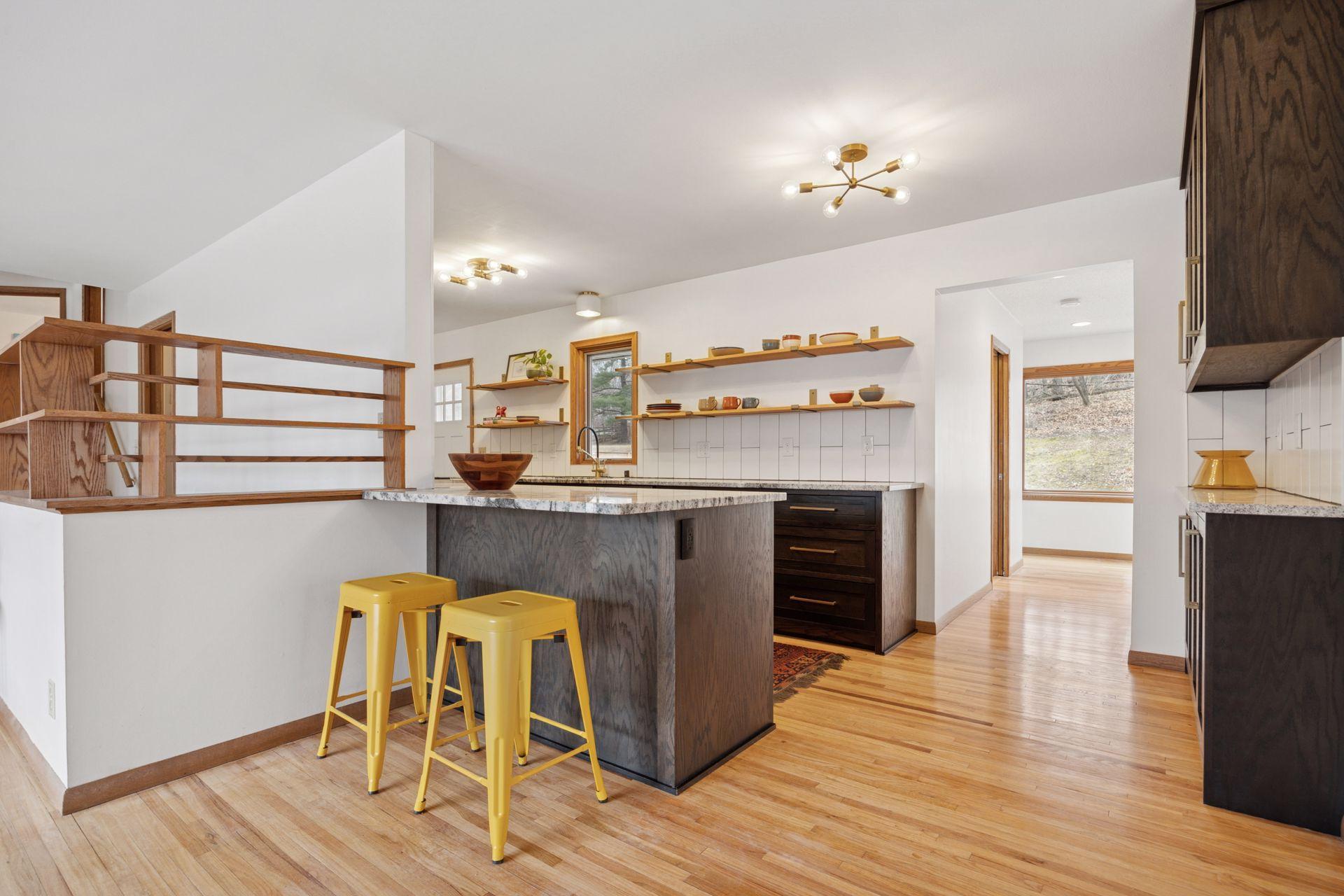 Living to kitchen and hallway to primary suite