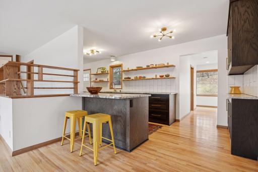 Living to kitchen and hallway to primary suite