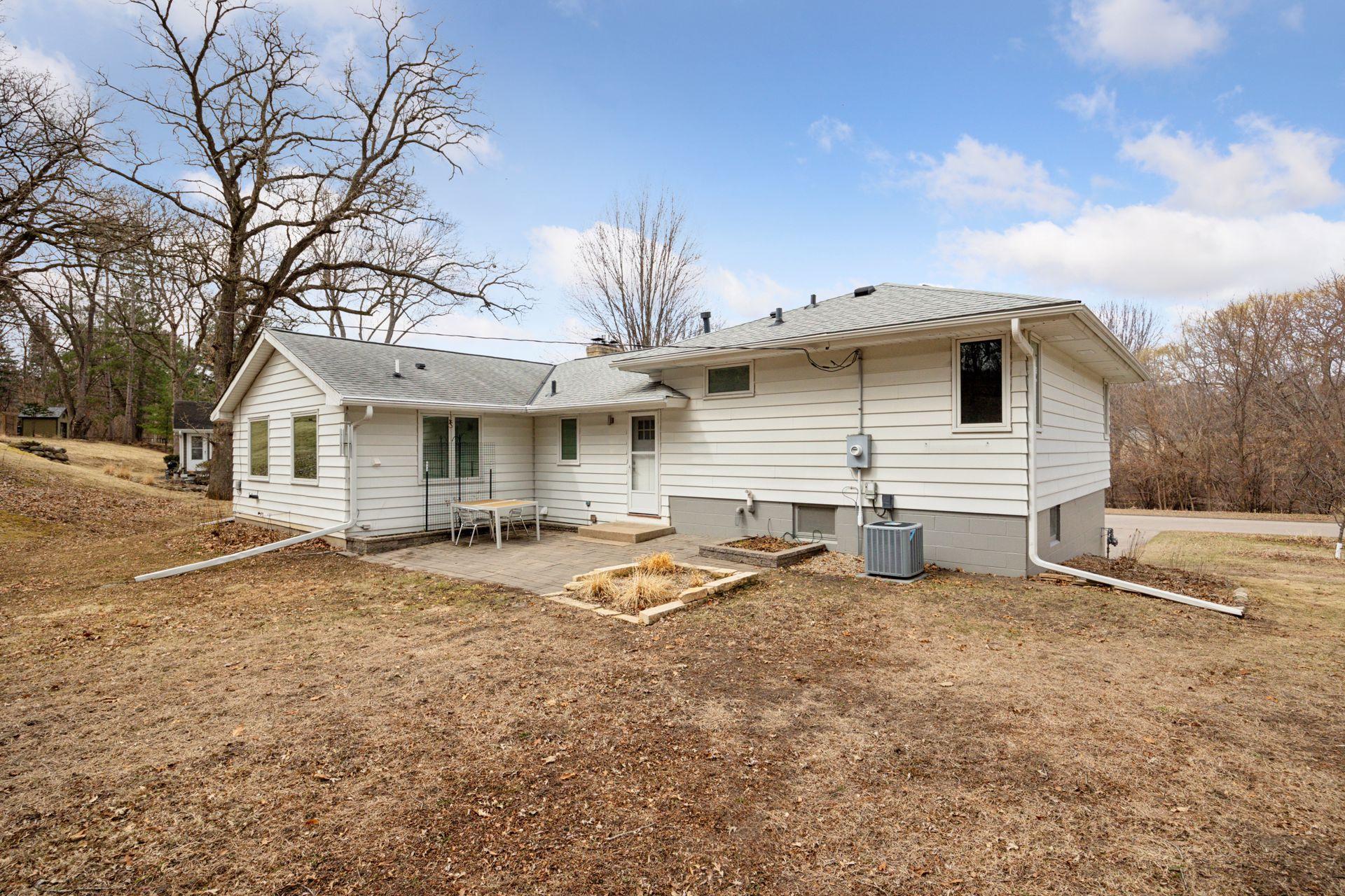 Back of home with paver patio off kitchen