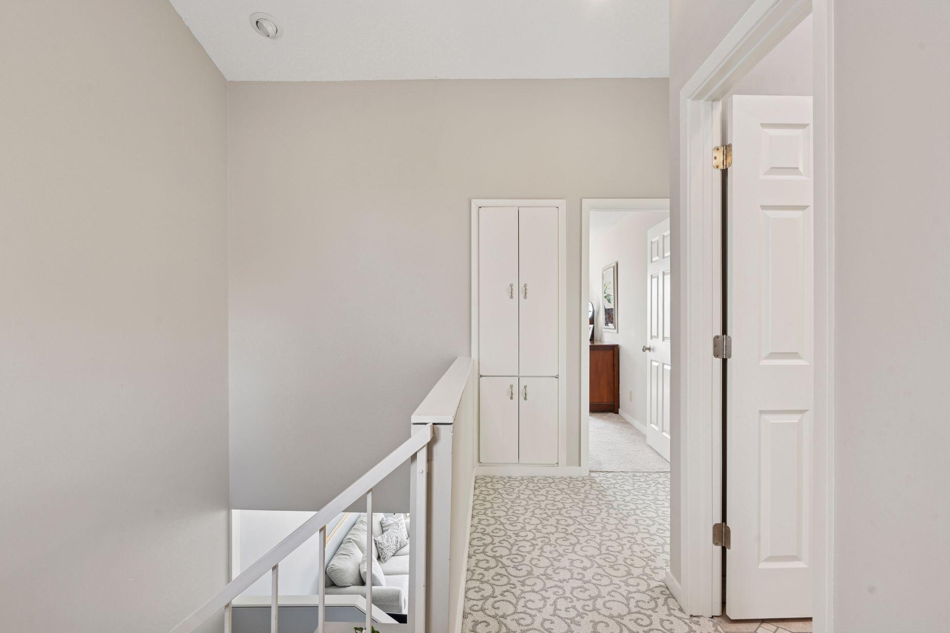 Bright open hallway is highlighted by skylights and a the path to 2 bedrooms.