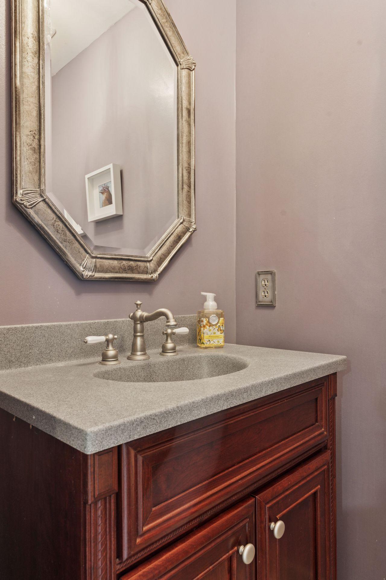Classically remodeled main level powder room.
