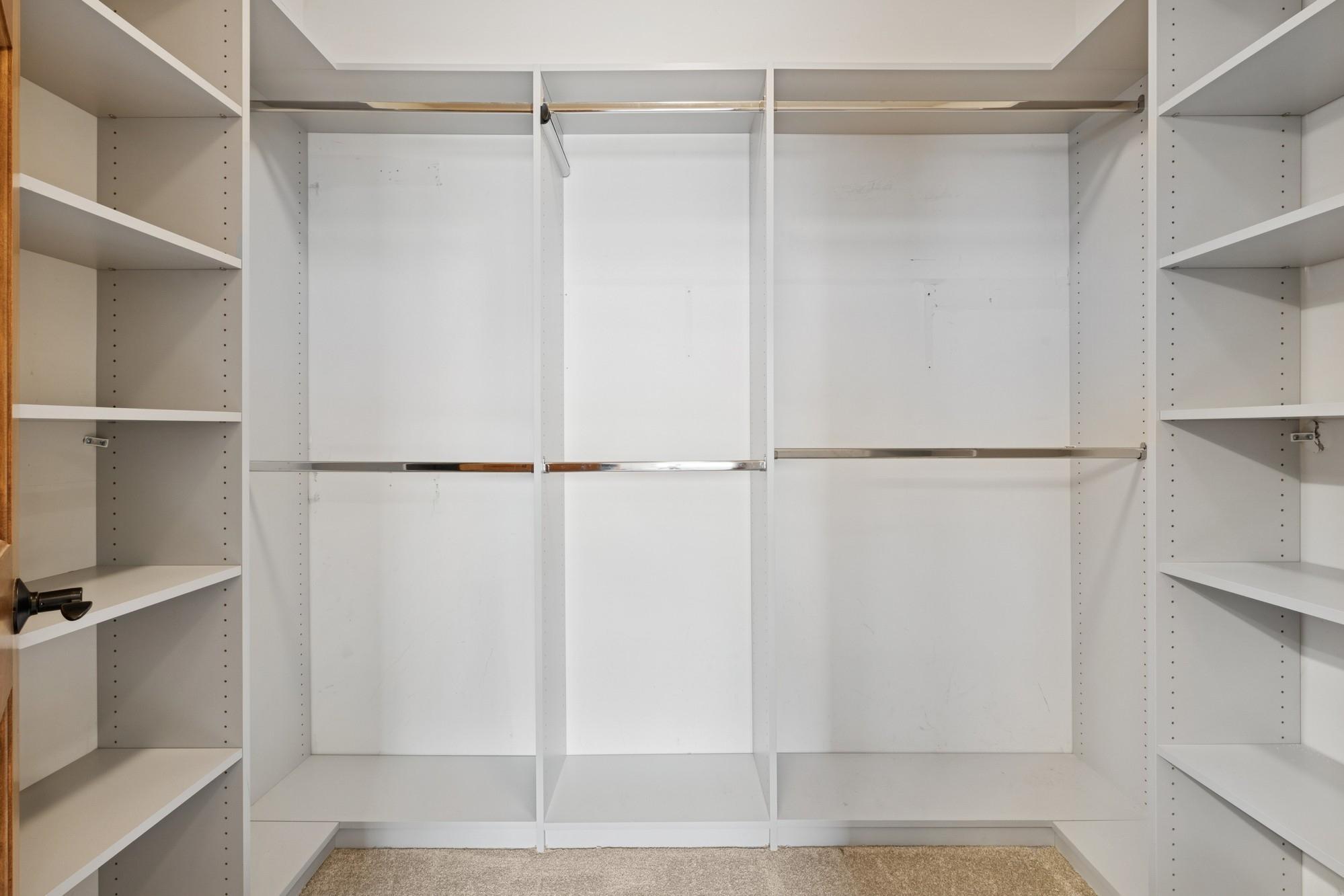 Primary Walk in closet with custom shelving