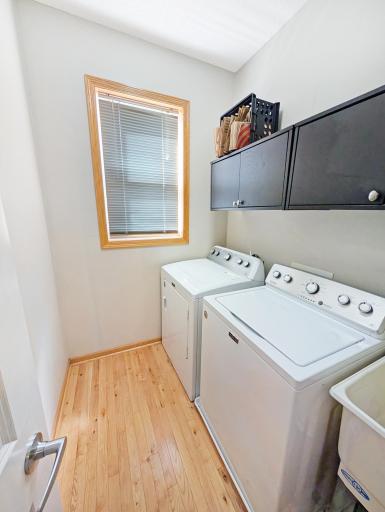 Main level laundry with storage and sink.