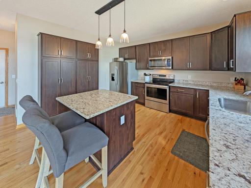 Kitchen features beautiful cabinetry and stainless steel appliances including a dishwasher.