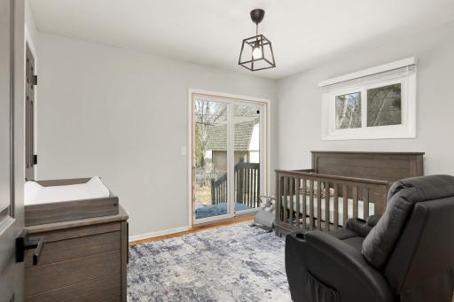 Second bedroom upstairs with sliding glass door to the backyard.