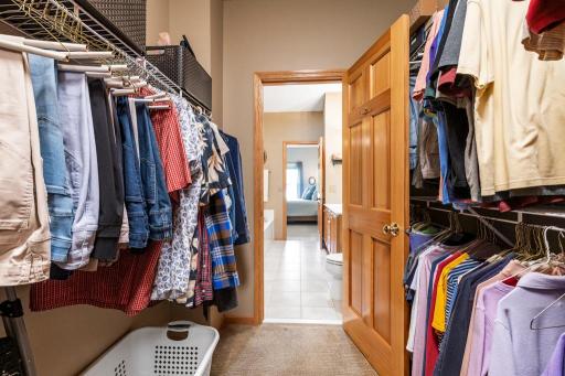 Primary closet and bath lead into the laundry area