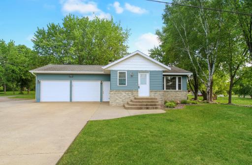 Great curb appeal with steel siding, brick accent and lots of beautiful landscape.