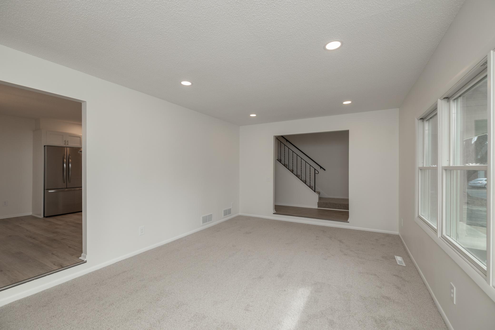 Main floor living room with new carpet and fresh paint