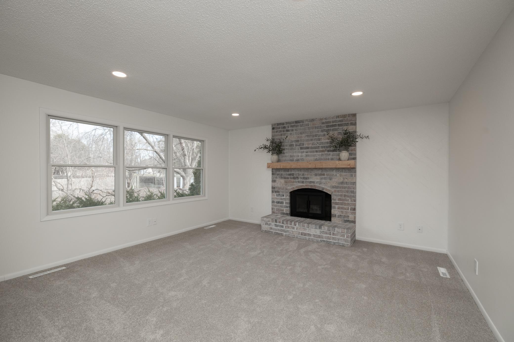 Main floor family room with new carpet, recessed lights and fresh paint