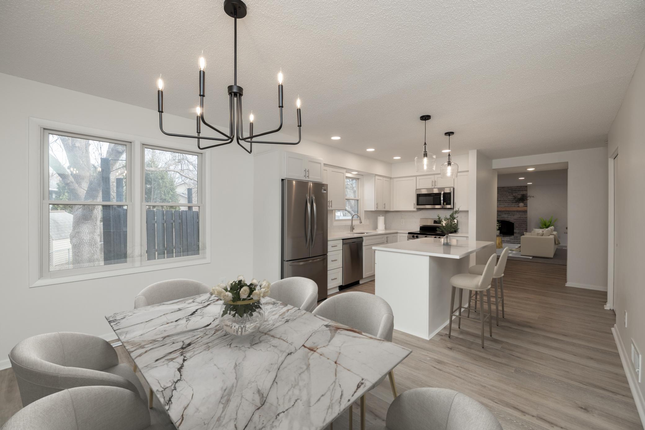 Virtually staged photo with view from dining room looking into the kitchen
