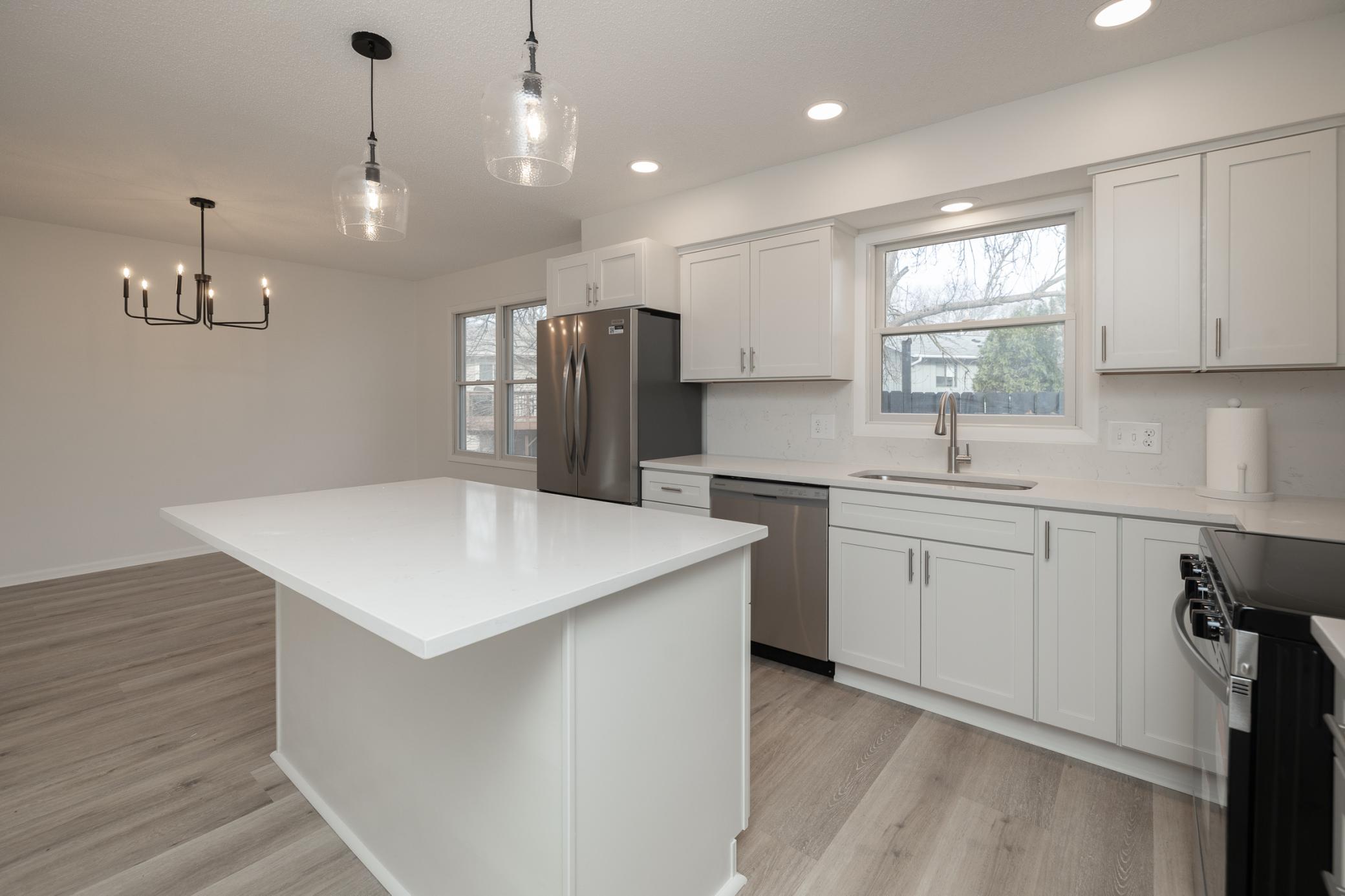 New cabinets, appliances, flooring, lighting and window overlooking spacious backyard