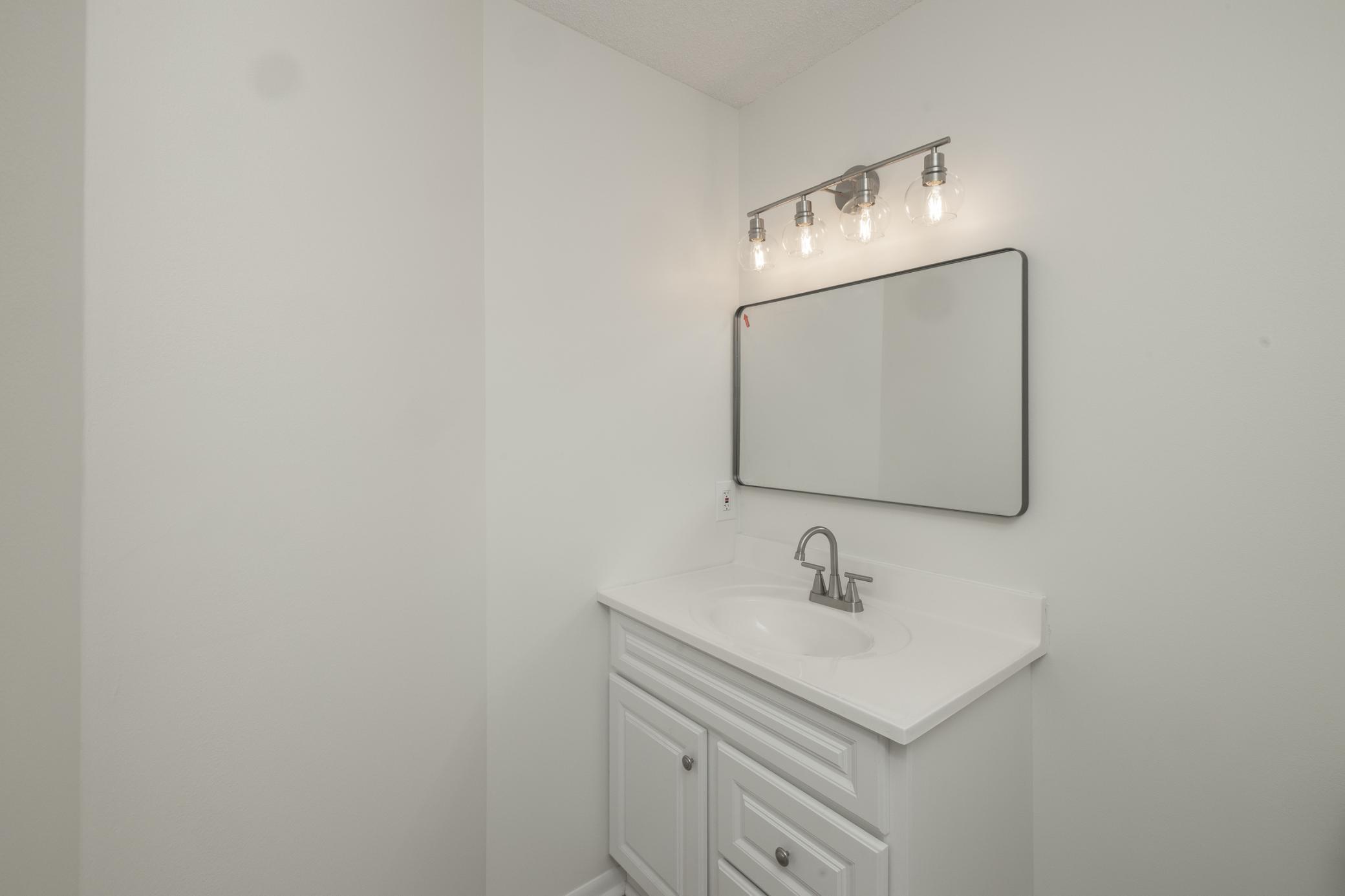 Main floor half bath with new lights, vanity and fresh paint