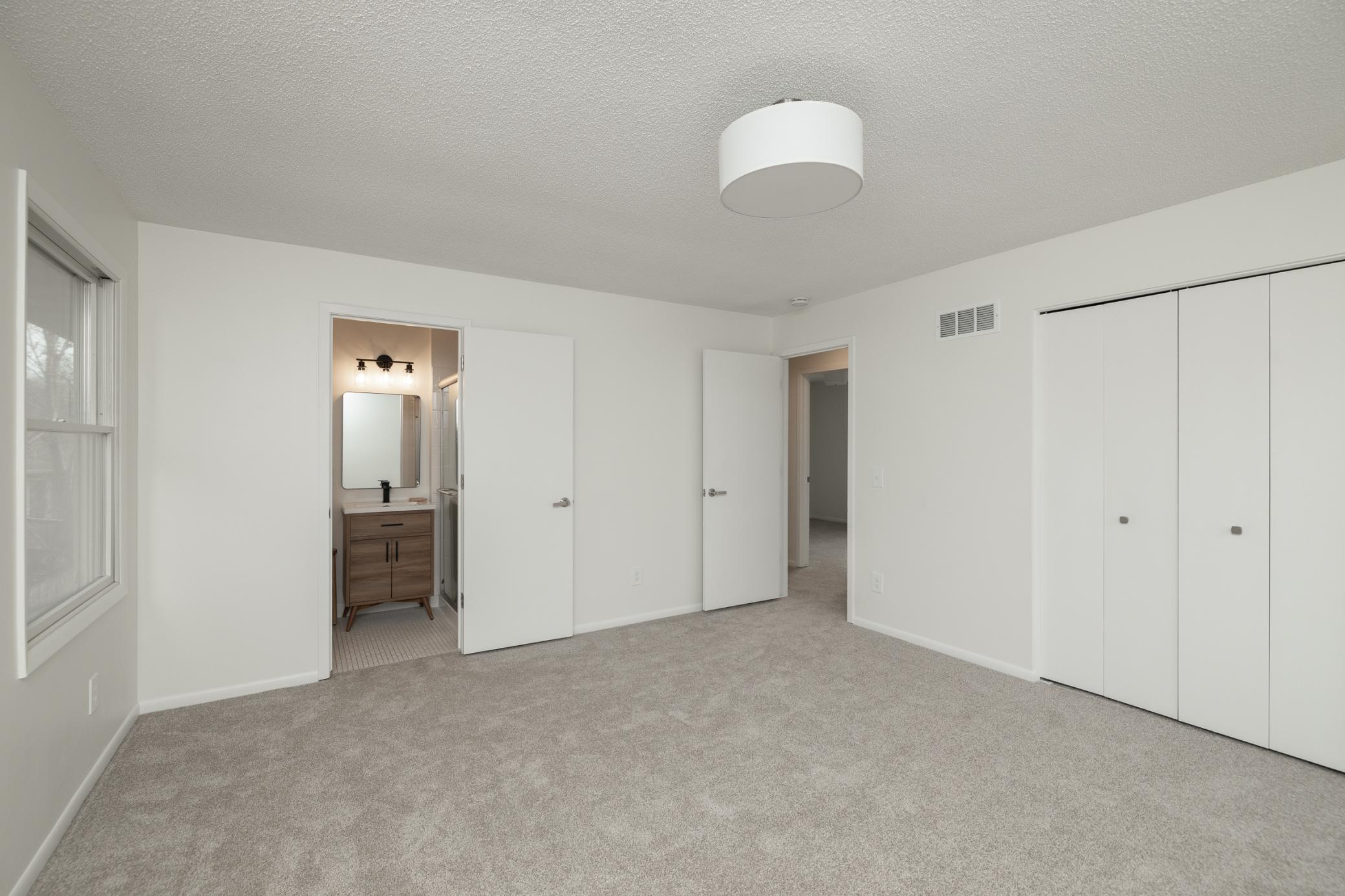 Upper level 15 x 14 master bedroom with new carpet, lighting and paint