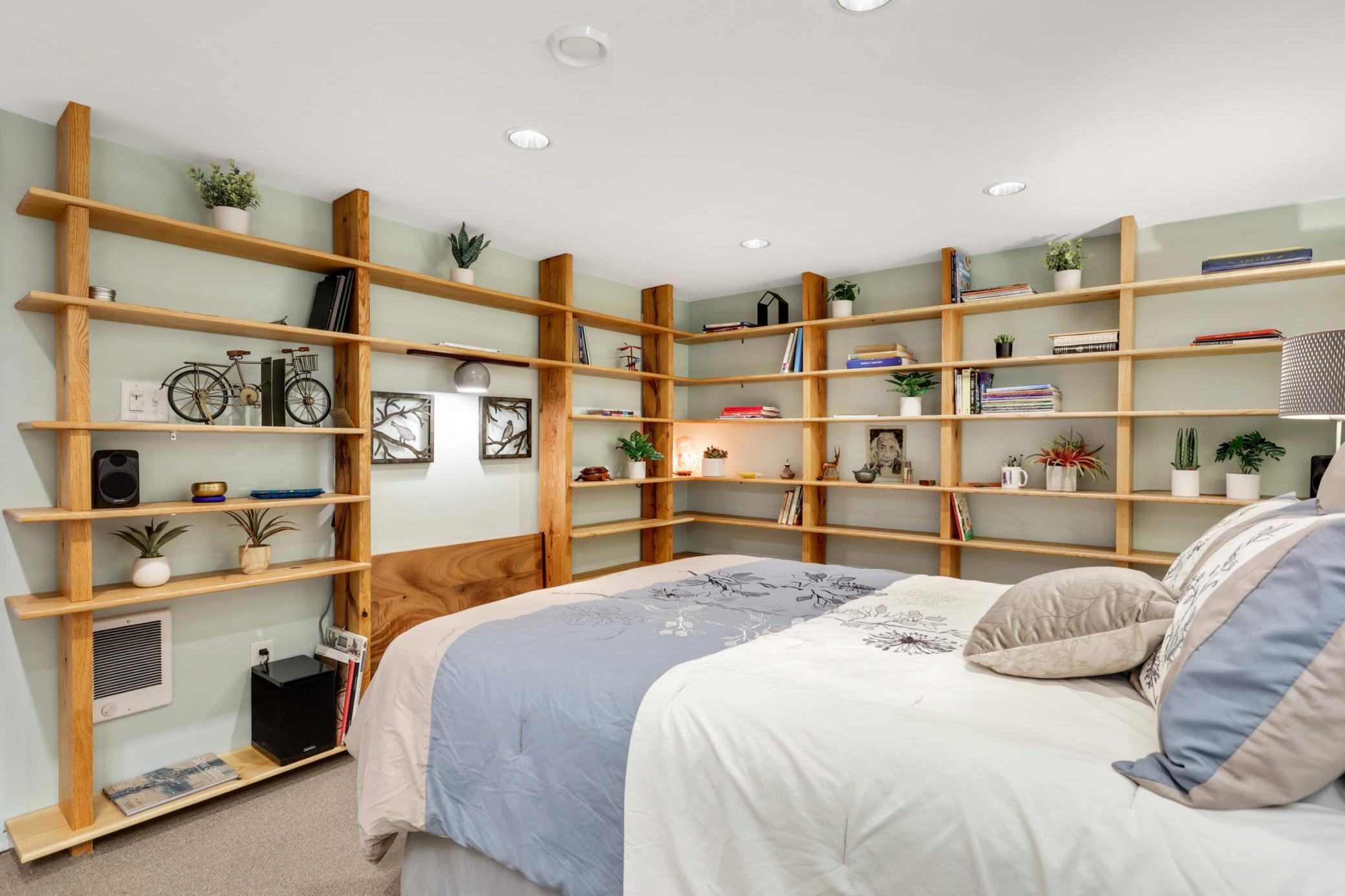 Functional guest room with a Murphy desk, offering a space-saving solution for work or study, along with ample open shelving for added organization.