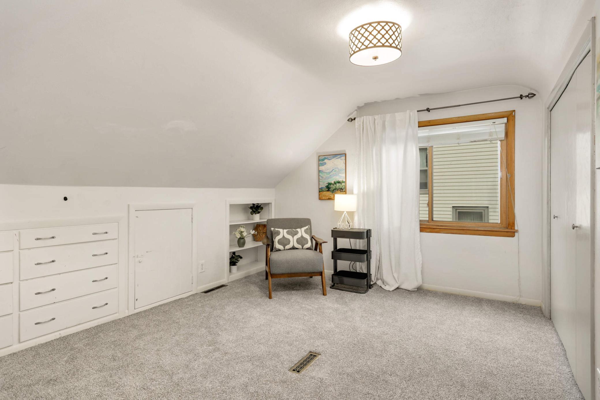Another charming upstairs bedroom with ample storage space, a generous closet, and a bright, inviting feel.