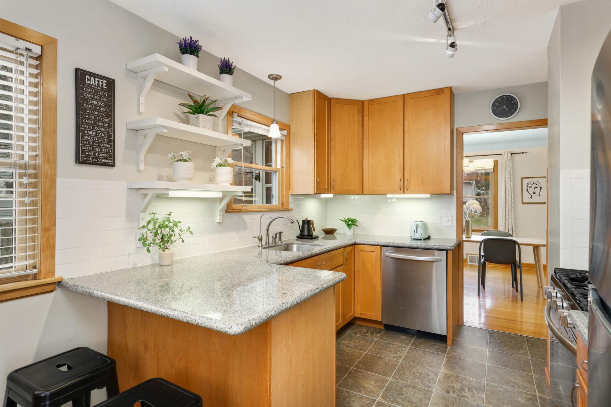 Cozy breakfast bar offers the perfect spot for casual meals or morning coffee.