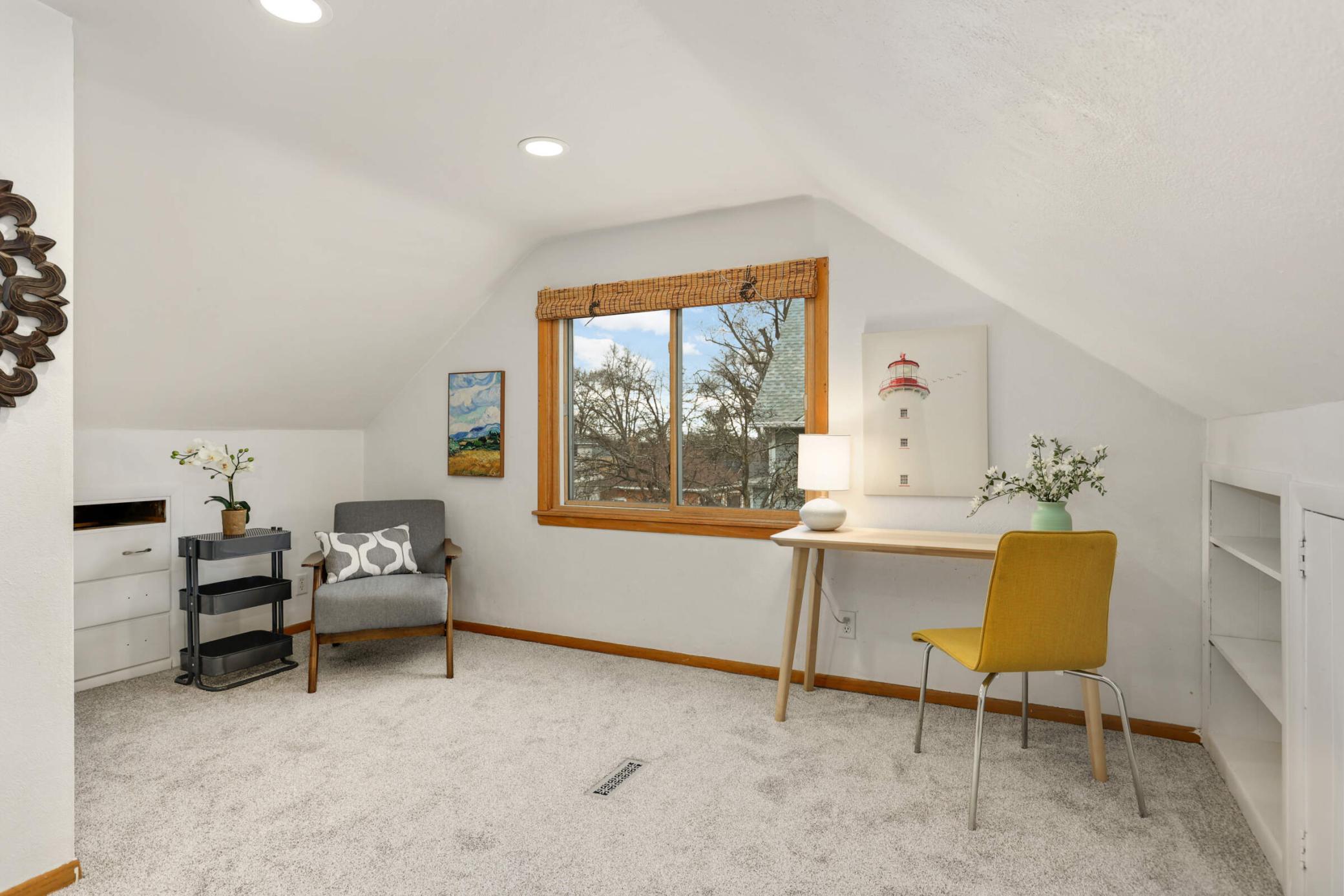 Cozy upstairs bedroom featuring ample storage space, with a generous closet and a bright, welcoming atmosphere—perfect for rest and relaxation.