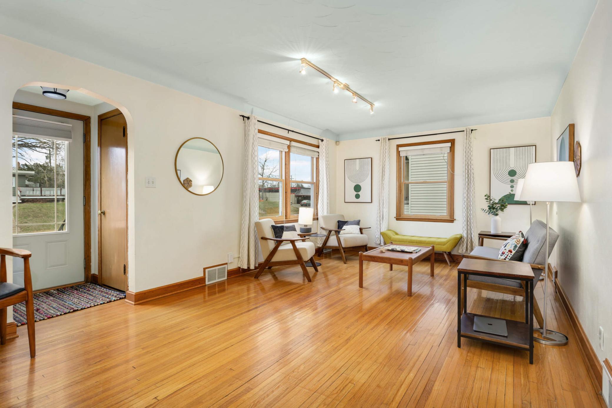 Sun-filled living room with windows on two walls, offering an open and airy feel with beautiful natural light throughout the day.