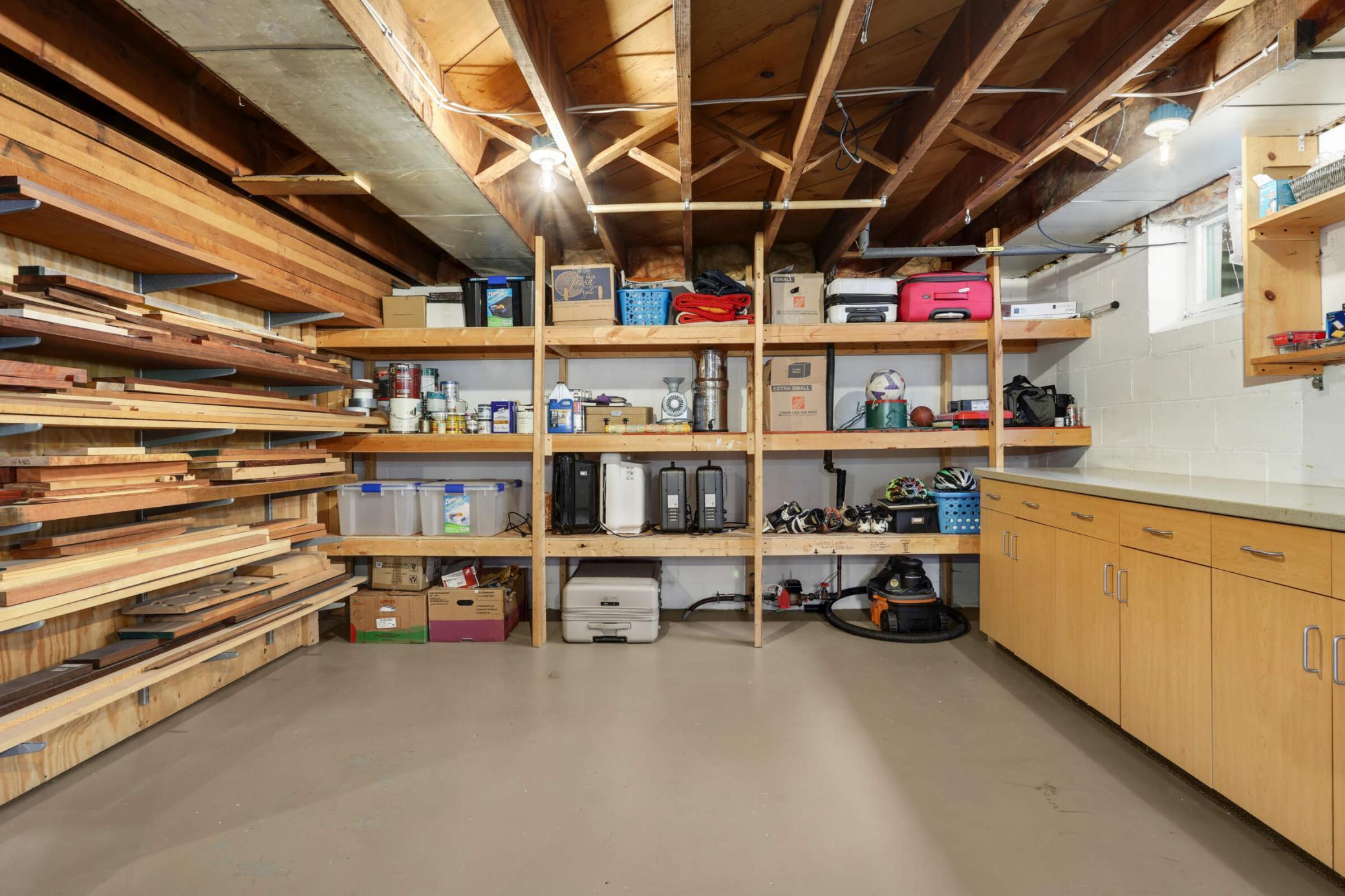 Basement is equipped with cabinets and shelves throughout, providing ample storage space and enhancing the organization of the entire lower level.
