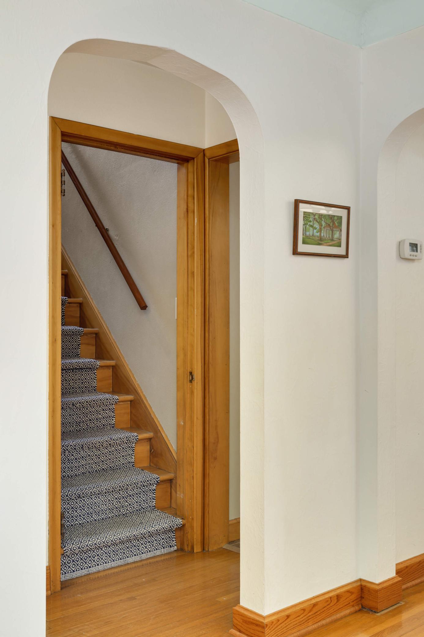 Charming arched pass-through, adding timeless character and a seamless transition, enhancing the home's open and inviting layout.