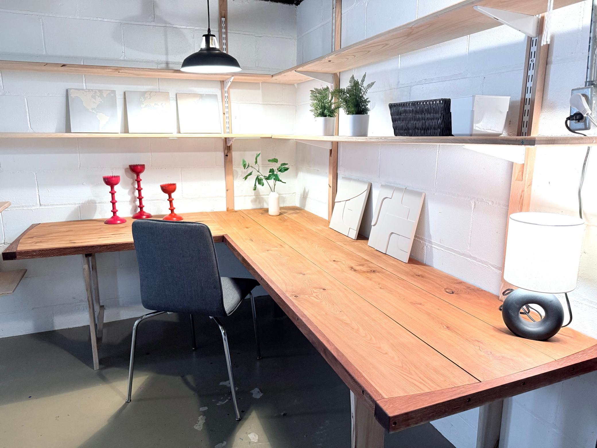 Basement features a beautifully crafted custom desk with built-in shelves, offering a perfect blend of style and functionality for an organized workspace or hobby area.