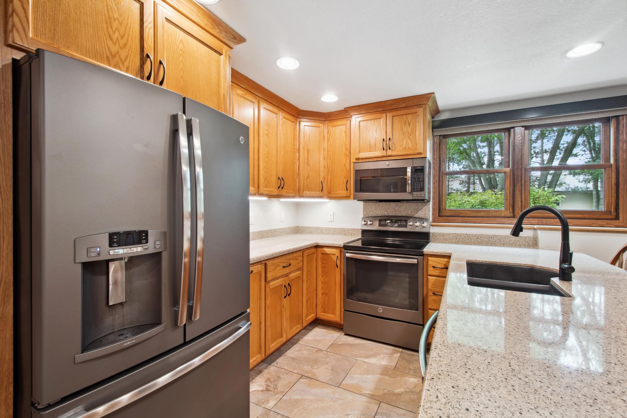 Tile flooring offers in-floor heat in this area. Tons of cabinet space.