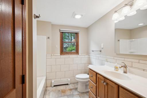 Ceramic tile, custom vanity, heated flooring in the full lower level bathroom.