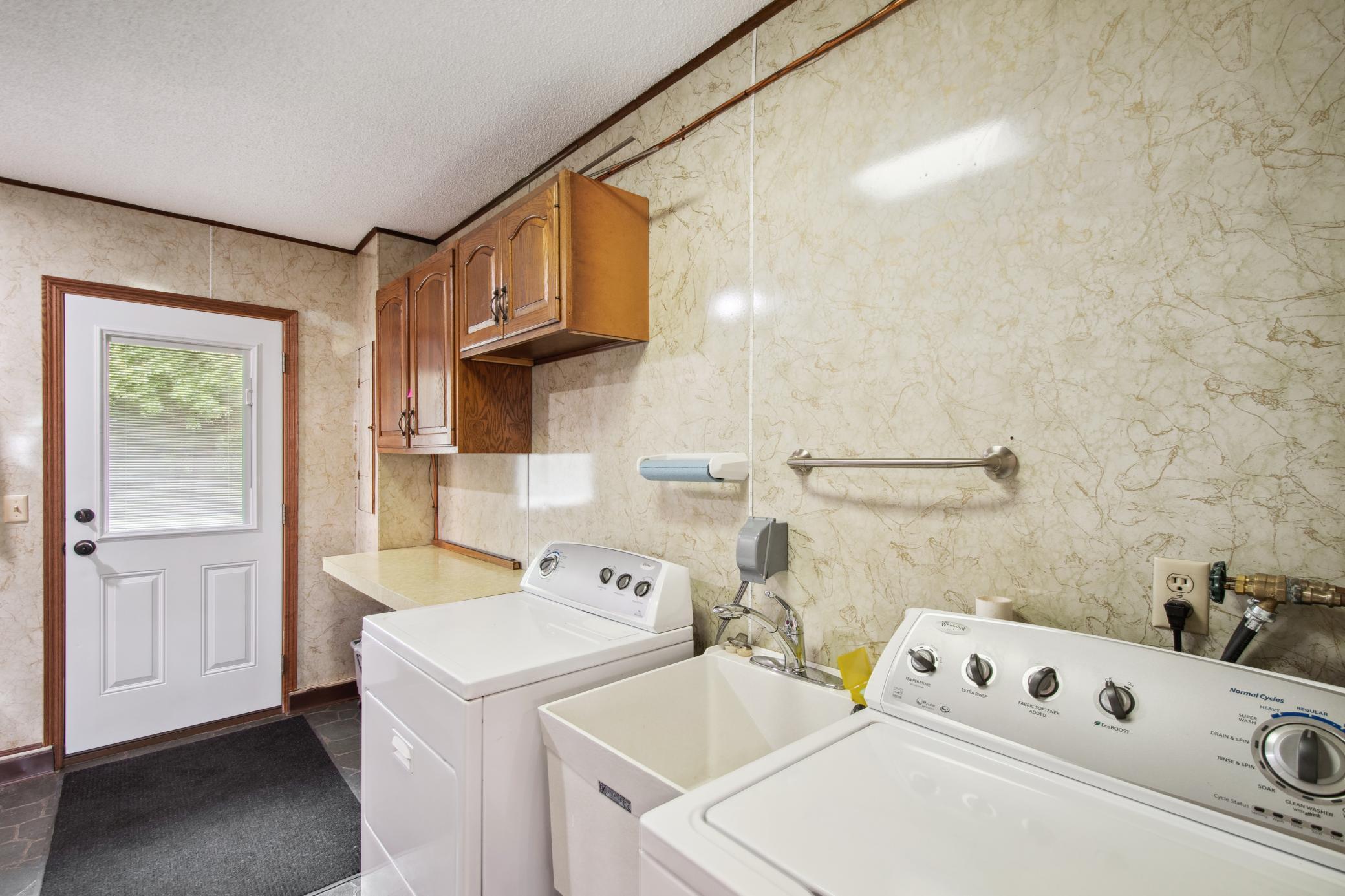 Main level entry area houses the utilities and the laundry area. New A/C in 2022, furnace in 2023, water heater in 2014.