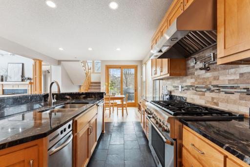 For the chef! Thermador range and cooktop with custom hood and pot filler
