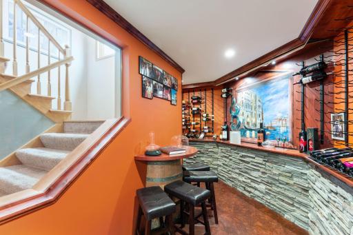 Walk-in wine cellar with tasting area and hand painted mural