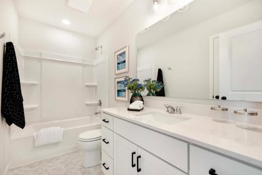 Large quartz countertop in upper level hall bath.
