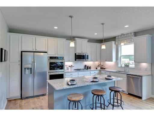 Built to perform, not even a single element was missed. Stunning stainless steel appliances, Quartz coated countertops (including the massive island) and an extra-deep pantry! What time is dinner!? Photo of model, colors and options will vary.