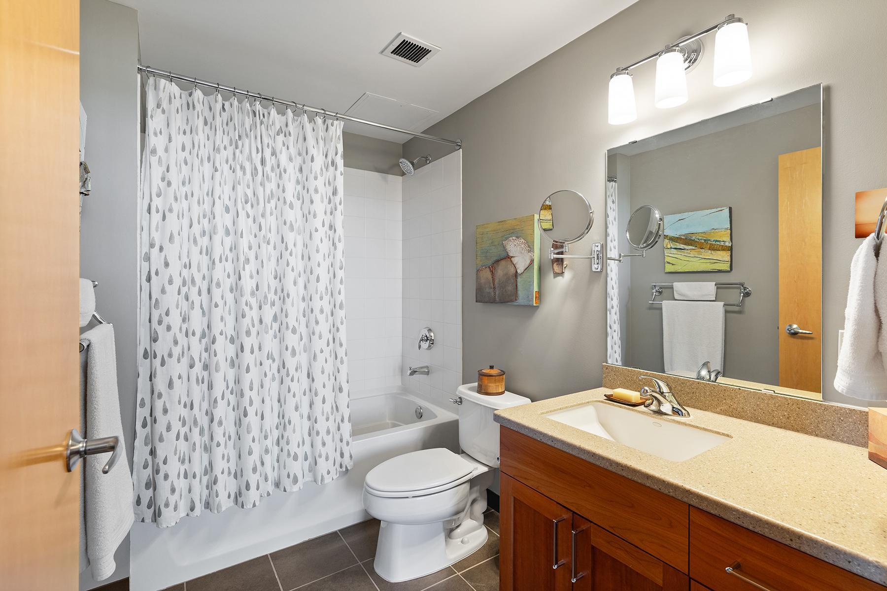 ...full private bathroom with quartz-top vanity and undermount sink...
