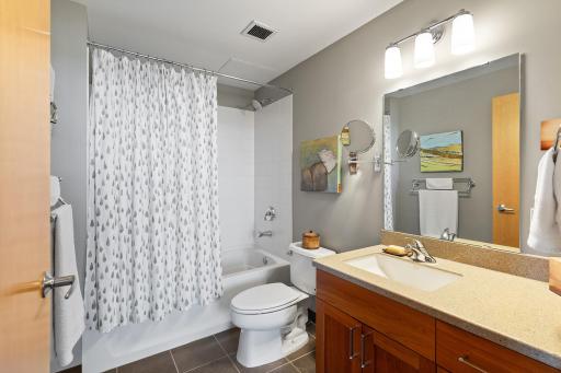...full private bathroom with quartz-top vanity and undermount sink...