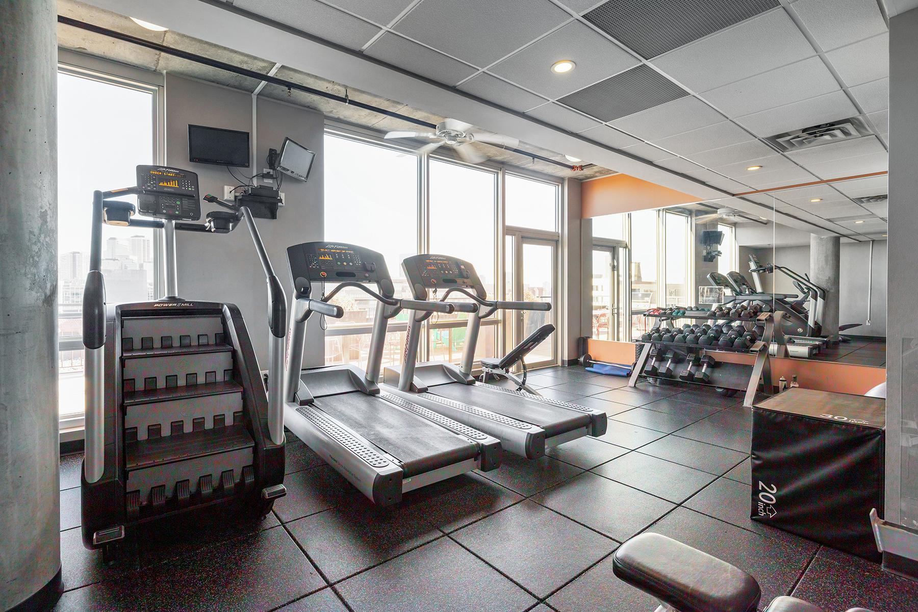 Exercise room with windows overlooking North Loop.