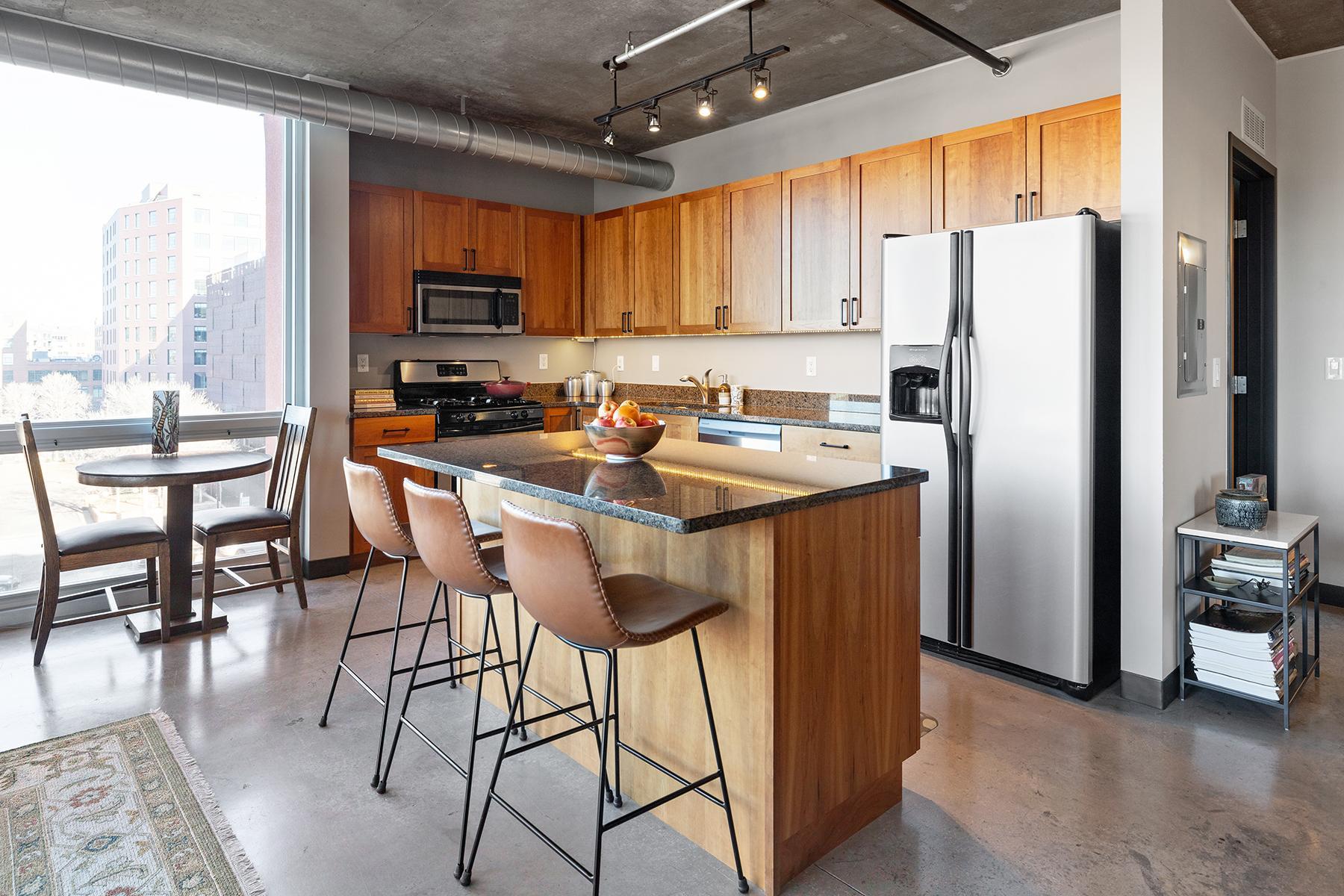 Kitchen with granite countertops, stainless steel appliances, island, and lots of cabinet space.