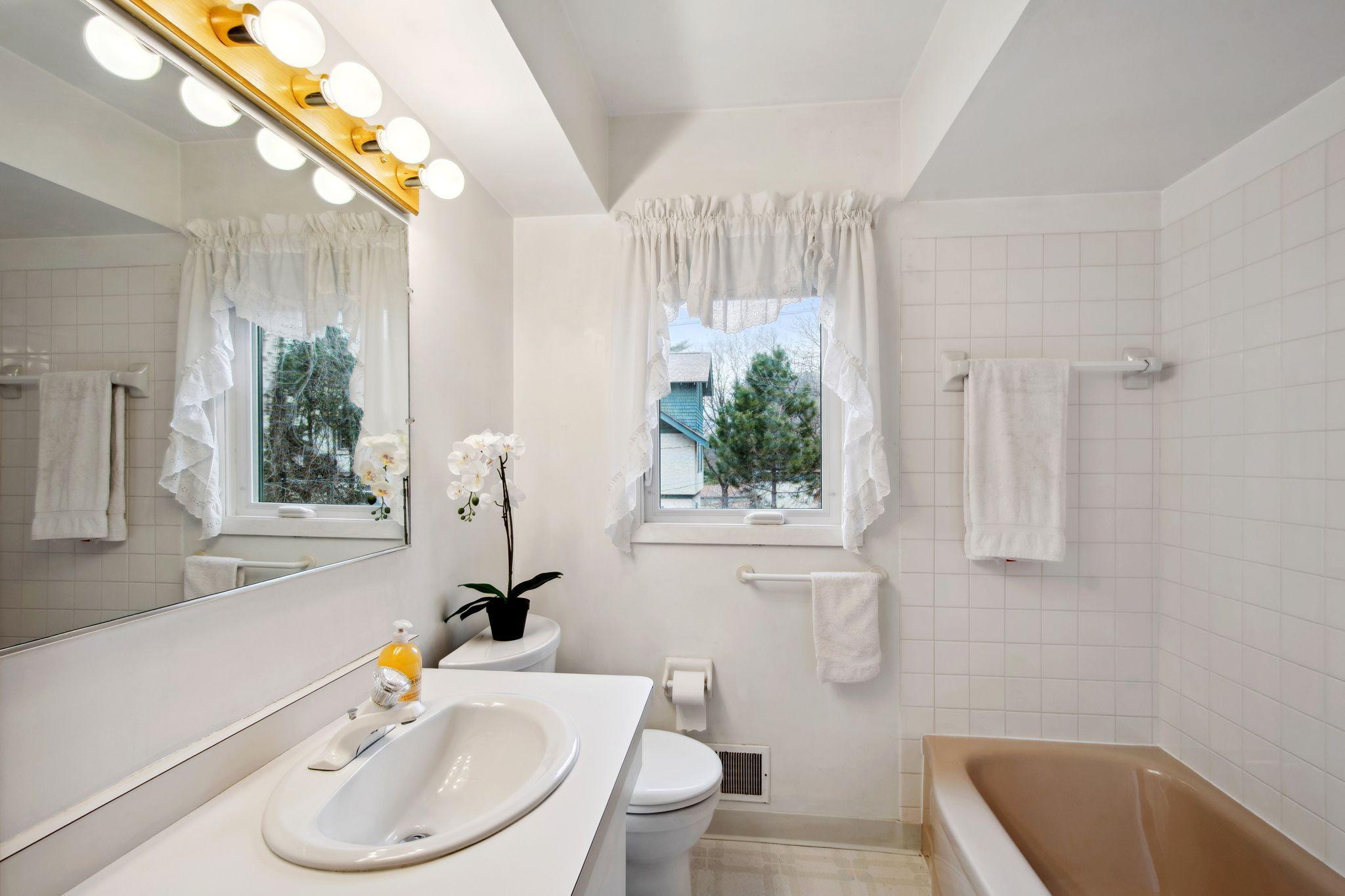 Main floor full bathroom. There is a closet in the bathroom on the right.