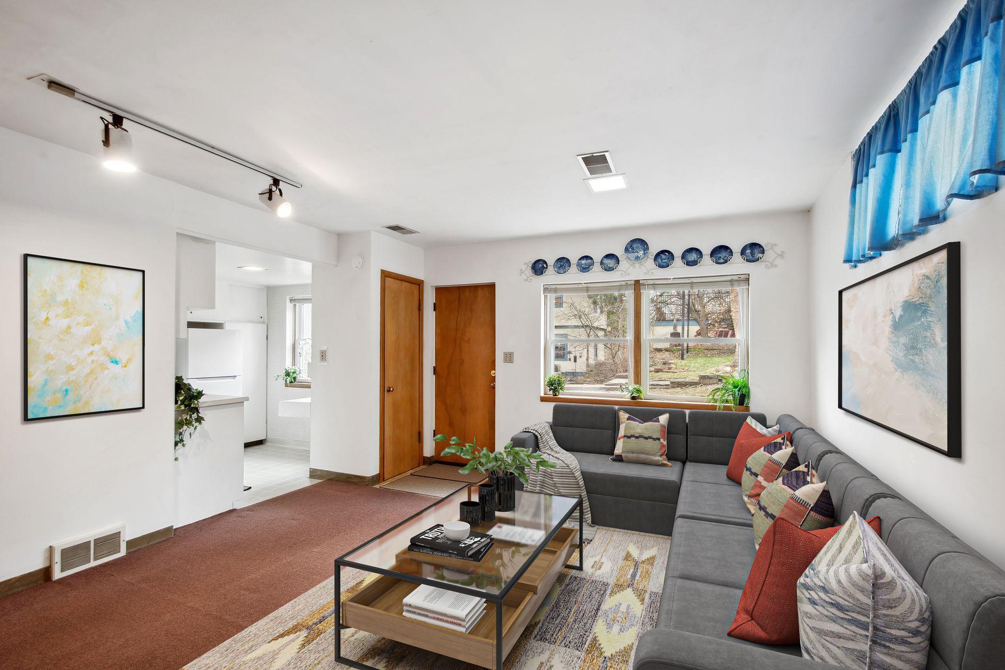 Virtually Staged living space on the 1st floor. There is a private entrance to this room straight ahead and a coat closet.