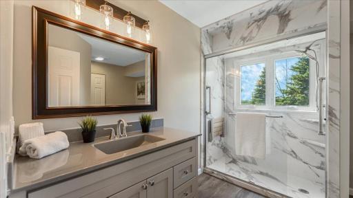 Newly remodeled bathroom with raised vanity and hard-surface countertops