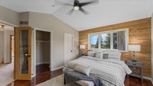 Primary bedroom with glass french doors and walk-in closet, access to remodeled 3/4 bathroom