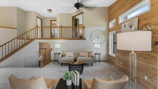 Living room with upper level primary bedroom overlooking